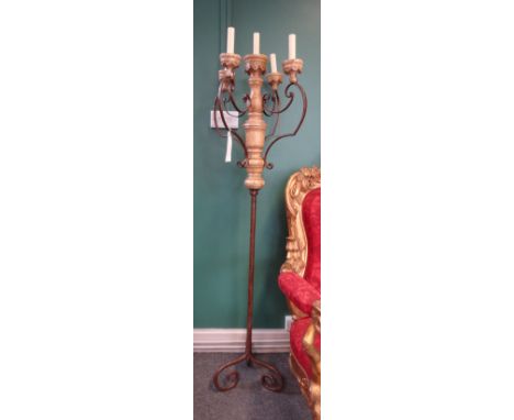 A pair of wrought iron and painted timber five light standing candelabra, possibly Italian or Spanish, fitted for electricity
