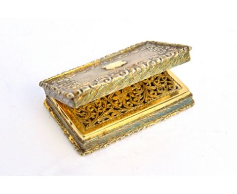 A Victorian silver gilt rectangular vinaigrette, with a floral and scroll engraved and pierced grille, the exterior engine tu