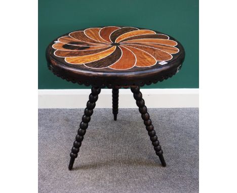 A 19th century Ceylonese occasional table, the circular bone and specimen wood inlaid top over carved and pierced frieze, on 