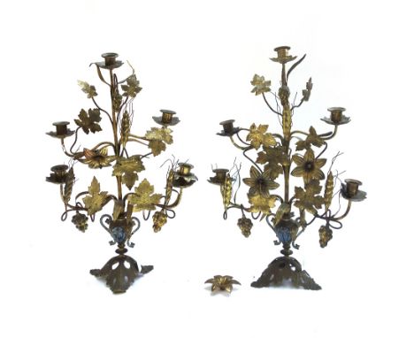 A pair of gilt metal five branch candelabra, late 19th/early 20th century, each cast as a bunch of flowers protruding form a 