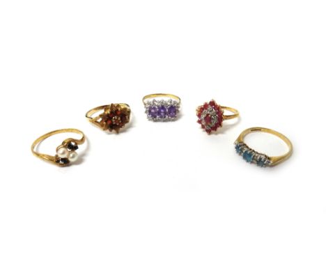 A 9ct gold and garnet set cluster ring, designed as a flowerhead, a 9ct gold ring, claw set with a row of three oval cut amet