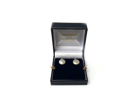 A pair of 9ct white gold, diamond and cultured pearl set earstuds, each with a button shaped cultured pearl and with a diamon