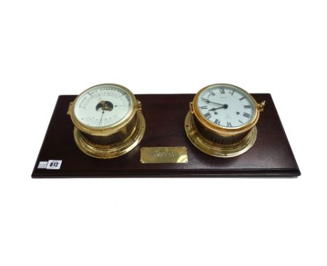 A modern brass ship's clock and matching barometer, mounted on a mahogany plinth with applied 'Engine Room' brass plaque, 61c