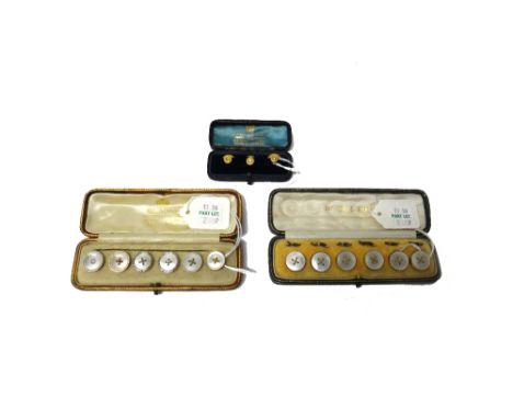 A set of three gold and diamond set dress studs, each mounted with a cushion shaped diamond, cased, six various mother of pea