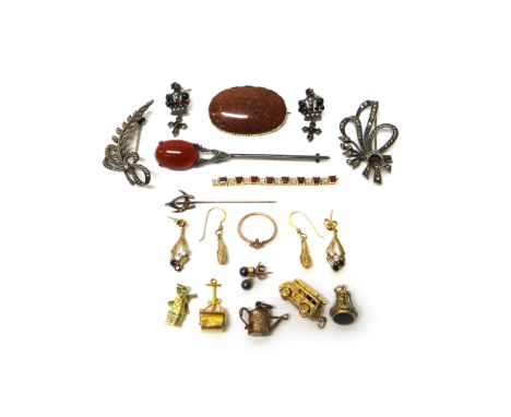 Three gold charms, comprising; a fire engine, a windmill and a garden roller, three further charms, two marcasite set brooche