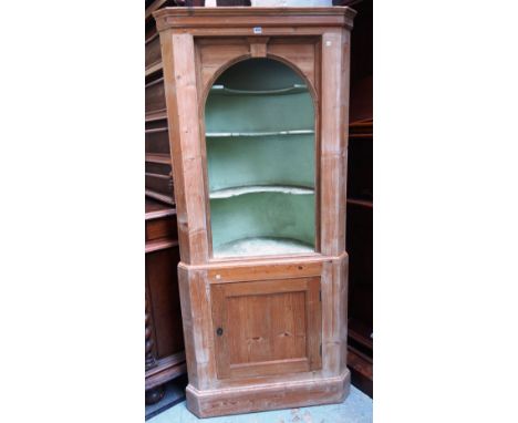 A late George III pine double height corner cupboard, with open shelf back over panelled cupboards, 90cm wide x 203cm high.