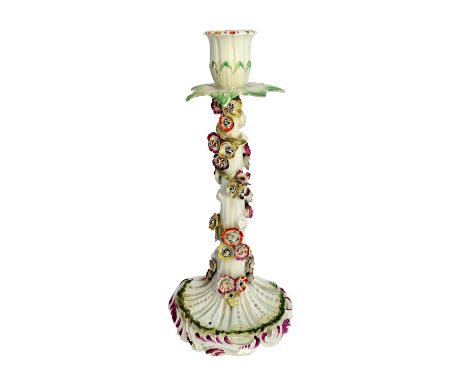 A rare Derby candlestick, circa 1758-60, modelled as a tree stump entwined with a stem of brightly coloured flowers beneath a