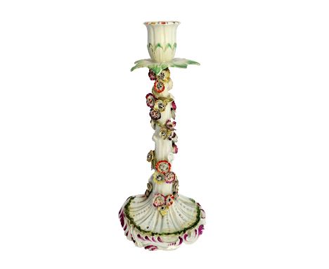 A rare Derby candlestick, circa 1758-60, modelled as a tree stump entwined with a stem of brightly coloured flowers beneath a