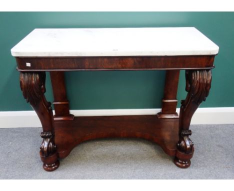 A 19th century console table, the rounded rectangular white marble top over a figured walnut base, with a pair of scroll supp