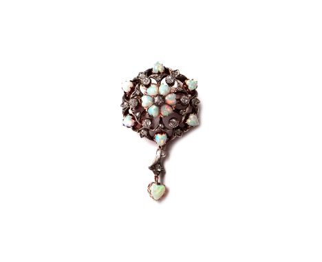 A Victorian opal and diamond set pendant brooch, of circular openwork form, mounted with a cushion shaped diamond at the cent