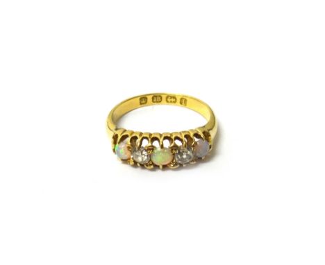 A Victorian 18ct gold, opal and diamond set five stone ring, mounted with three circular opals and with two cushion shaped di