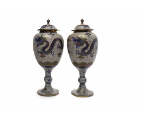 PAIR OF EARLY 20TH CENTURY CHINESE CLOISONNE LIDDED VASESdecorated with dragons chasing the flaming pearl, 32cm high 