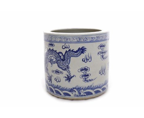 MID 20TH CENTURY CHINESE BLUE AND WHITE BRUSH POT decorated with dragon chasing the flaming pearl, six character mark to base