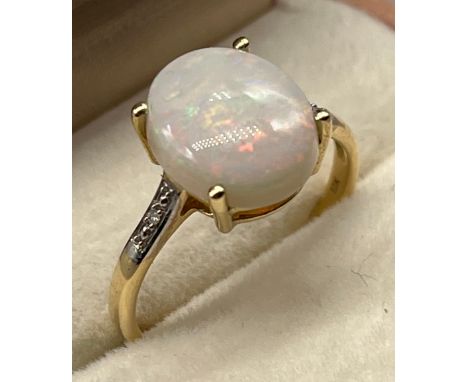 10ct yellow gold ladies ring set with a large single opal off set by diamond shoulders. [Ring size R] [2.68Grams] [1.2x0.9cm-