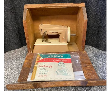A Vintage Singer Sewing Machine Model 40K. Comes with a wooden carry case and manual 