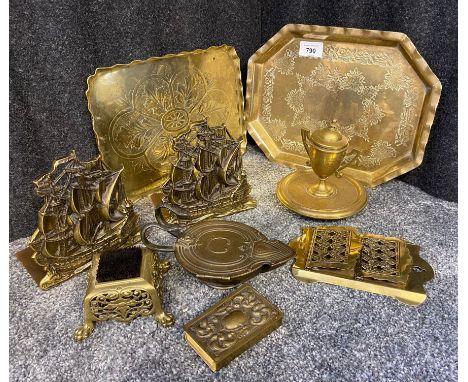 A Selection of arts and crafts and antique brass wares to include two brass worked trays, a pair of galleon ship bookends, an