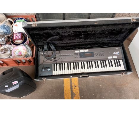 Korg keyboard in a hard back case long with speaker and headphones 
