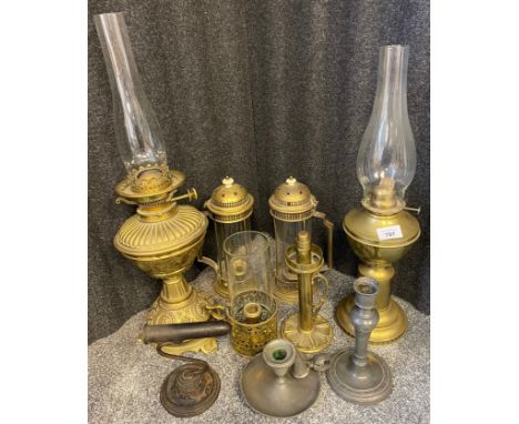 A collection of antique lanterns to include ornate brass paraffin lamp, pewter candle holder with snuff and three brass and g
