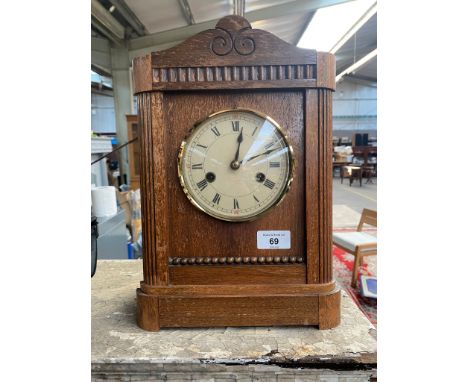 Antique oak cased mantle clock. Comes with pendulum. 