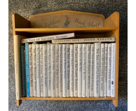 Antique/ vintage Peter Rabbit bookshelf containing various Beatrix Potter books 