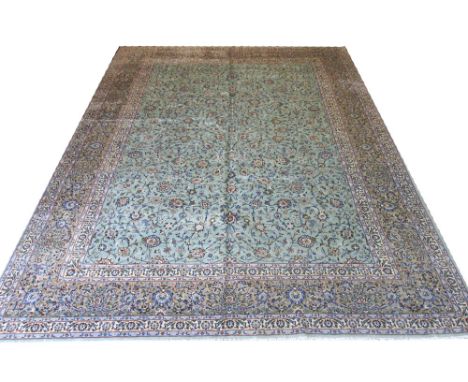 FINE KASHAN CARPET, 425cm x 315cm, all over palmette & vine design on a jade field within multiple corresponding bands and bo