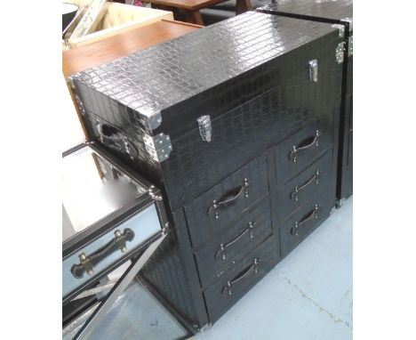 TRUNK/CHEST having rising top above six short drawers in crocodile skin patterned black leather, with strap handles on wheels