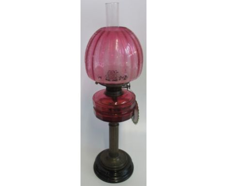 A Victorian oil lamp with cranberry bowl and etch glass cranberry shade. Condition Report: Damage to reservoir and chips to t