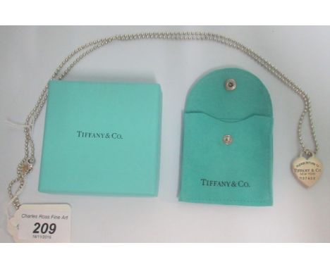 Tiffany &amp; Co:  a silver necklace, the heart-shaped necklace inscribed and numbered, on bead chain also marked 'Tiffany', 
