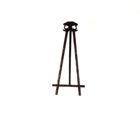 A Chinese hongmu bench easel, with carved lotus decoration