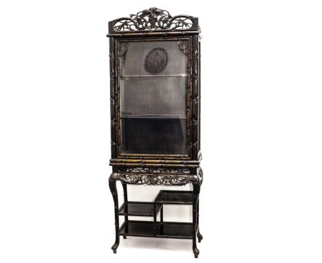 A 1920s Chinese hongmu display cabinet, with grape and bamboo carvings to the frame, and with multi shelf stetcher base