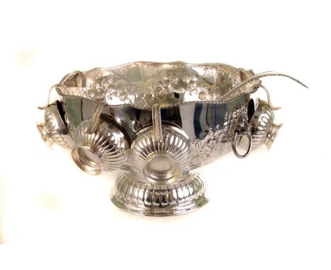 A large silver plated fruit bowl, having repousse floral design, together with cup plated cups and a ladle (8)