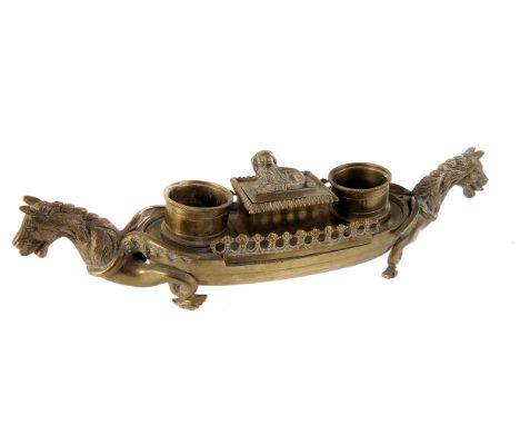 A brass inkwell, in the style of a Viking longboat, having mythological creatures to either end, AF