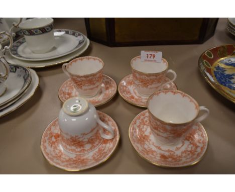 Four Doulton Burlsem coffee cups and saucers having musical instrument pattern an gilt edging.
