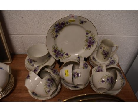 A part tea service having purple floral print