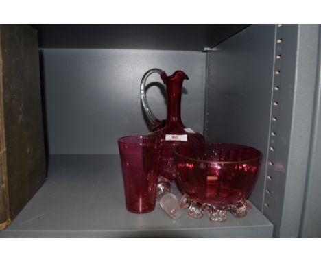 A cranberry glass decanter,beaker and footed bowl.