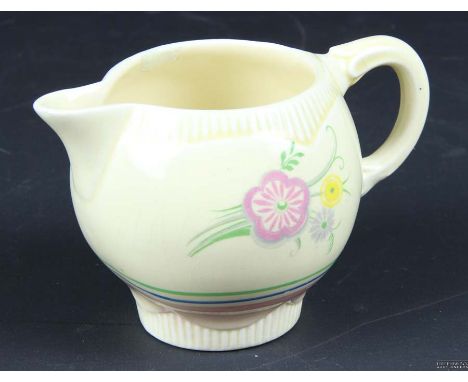 A Clarice Cliff Pottery small jug,c1936, printed with Matana pattern, the moulded jig printed with stylised pastel floral spr