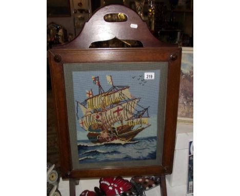 A 1930' to 50's oak framed wool work tapestry of a galleon fire screen, COLLECT ONLY
