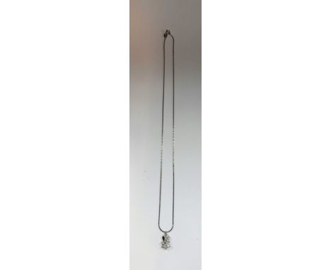 A WHITE GOLD AND DIAMOND PENDANT attached to a white gold fine link chain