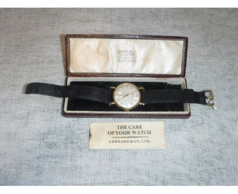 GARRARD: A GENTLEMAN'S 9CT YELLOW GOLD WRISTWATCH, the round dial with Arabic numerals and subsidiary seconds dial, attached 