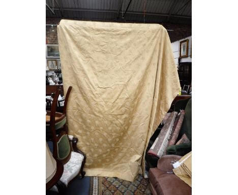 A LARGE PAIR OF GOLD SILK LINED CURTAINS decorated with trees
