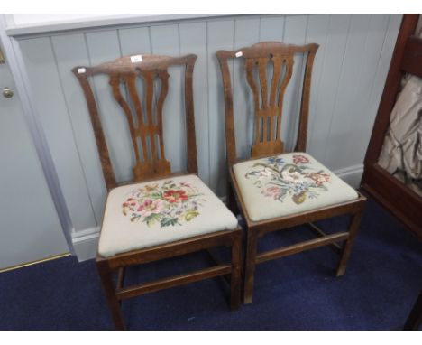 A PAIR OF GEORGE III 'COUNTRY CHIPPENDALE' OAK CHAIRS with needlework upholstered seat