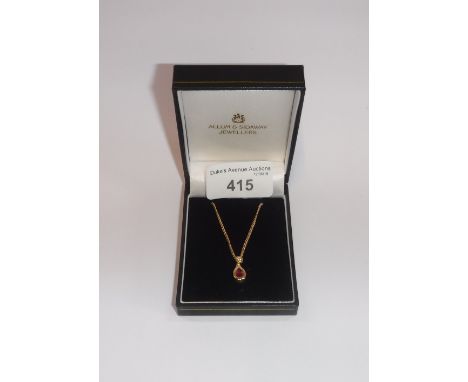 A 'RUBY AND DIAMOND' PENDANT on an 18ct yellow gold chain