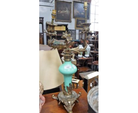A CONTINENTAL TWO BRANCH TABLE LAMP of Rococo design with a green glazed ceramic centre