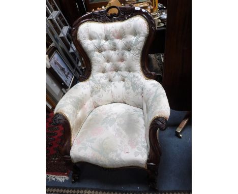 A VICTORIAN BUTTON-BACK ARMCHAIR with carved mahogany frame