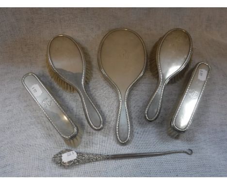 A SILVER-BACKED DRESSING TABLE SET and a button hook