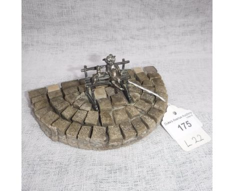 W.G. (WILLIAM GEIGER) CIRCA 1904-07; A SILVER PUTTO AND WHIPPET on a bench, mounted on a tessellated mosaic base