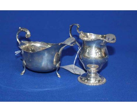 SILVER HELMET SHAPED CREAM JUG
hallamrked Chester 1914 and a silver sauce boat with open scroll handle, Birmingham (2)