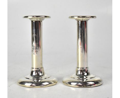 A pair of hallmarked silver loaded candlesticks with incised laurel wreath decoration, height 13.5cm, marks rubbed (2). CONDI