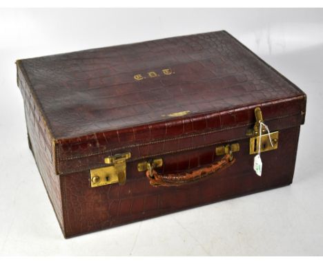 A Victorian crocodile moire silk lined fitted vanity case, containing cut glass vanity bottles with hallmarked silver tops, L