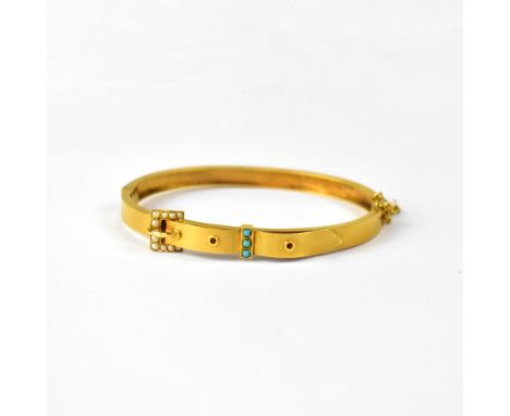A 9ct yellow brushed gold bangle in the form of a belt and buckle, set with seed pearls and small turquoise stones, approx 9.